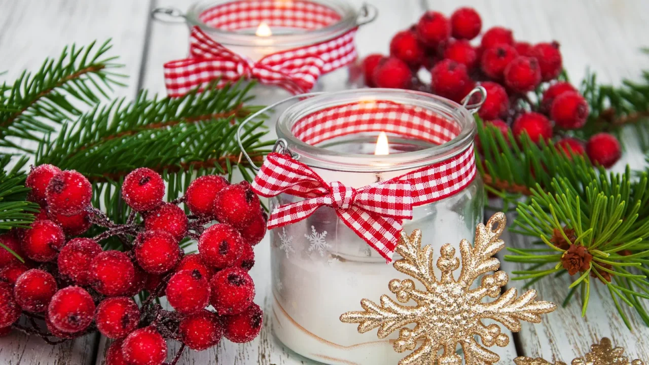 christmas decorations candles in glass jars with fir