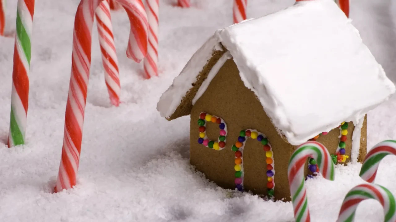 christmas footprints leading to gingerbread cottage