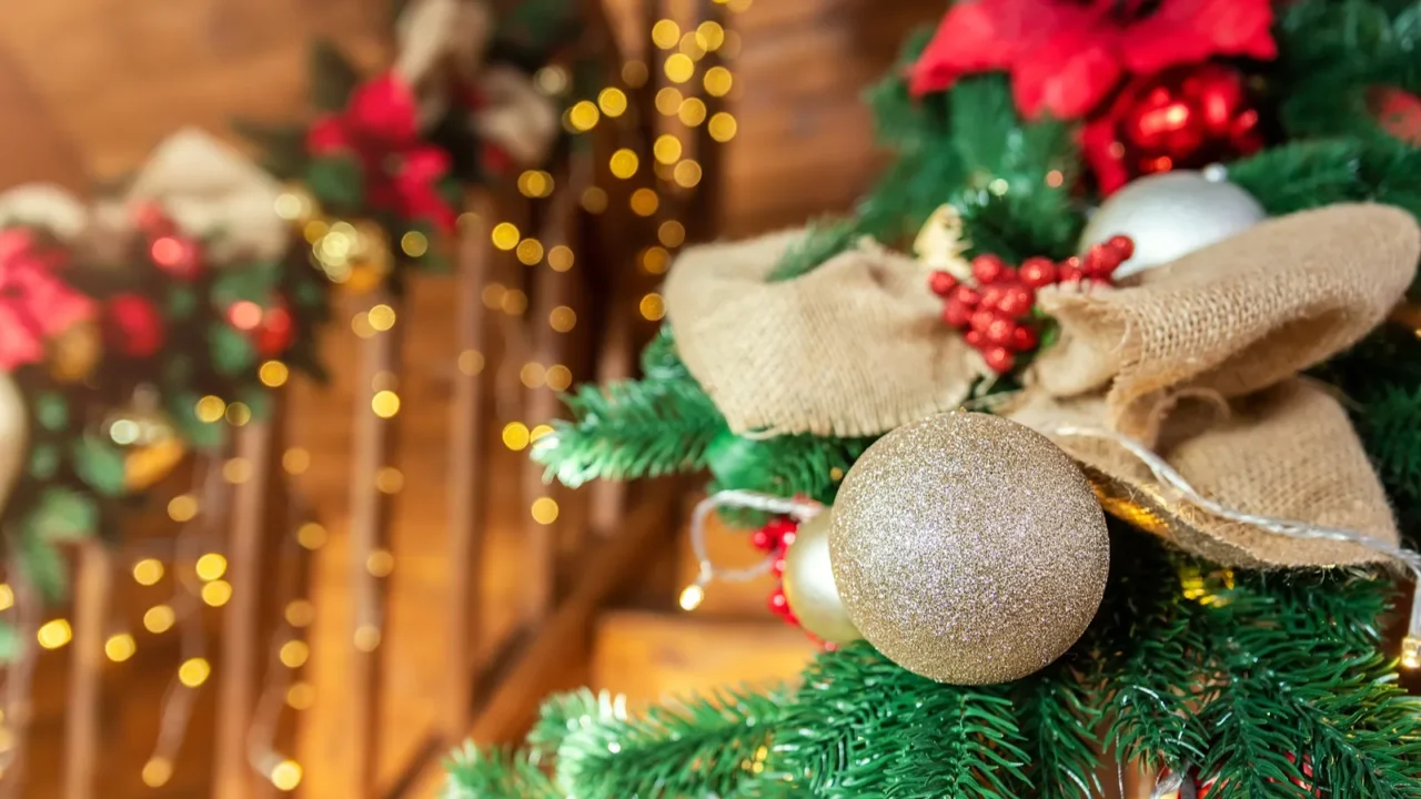 closeup house wooden staricase handrails railings decorated with artificial holly