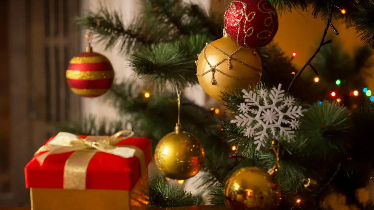 closeup image of christmas gift box with golden ribbon next