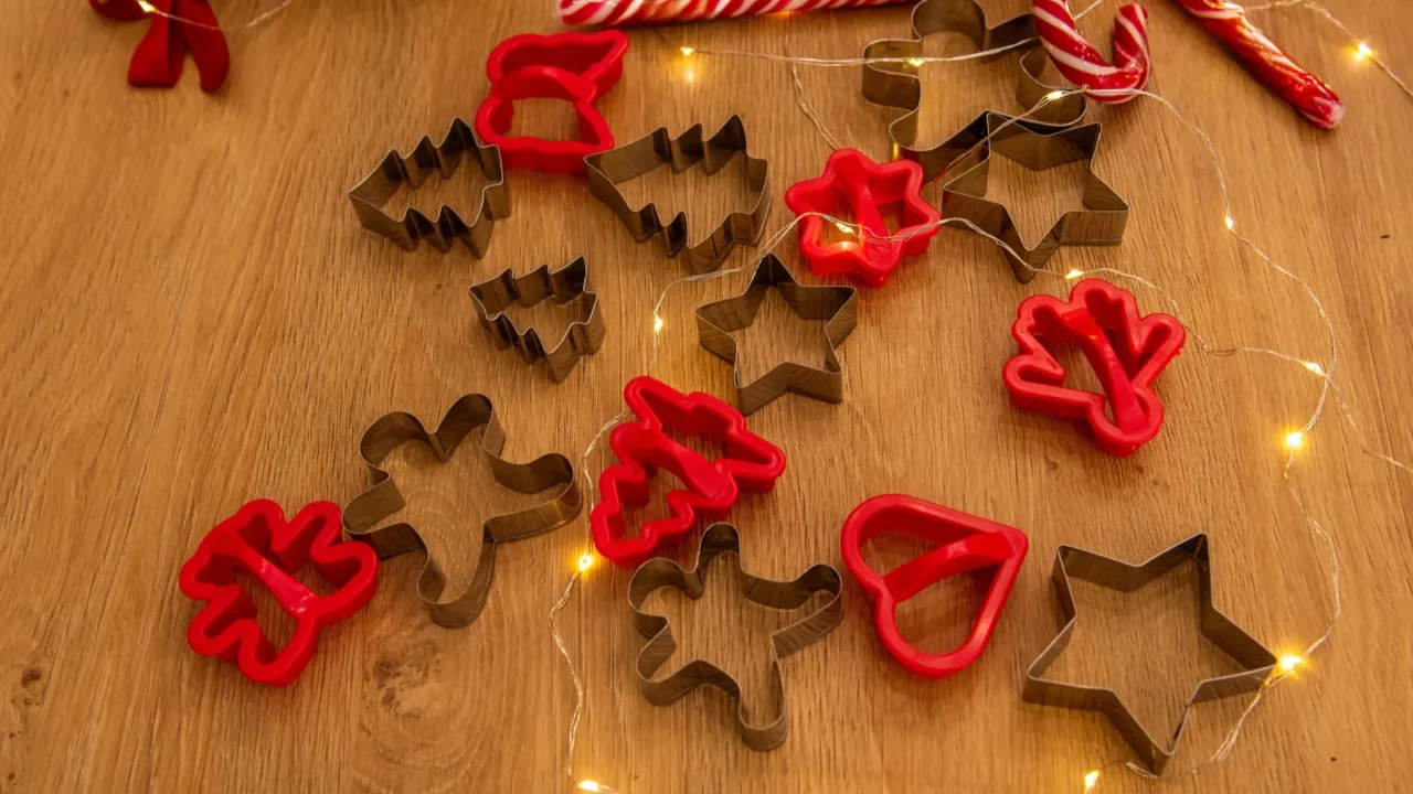 collection of christmas themed cookie cutters including shapes like stars