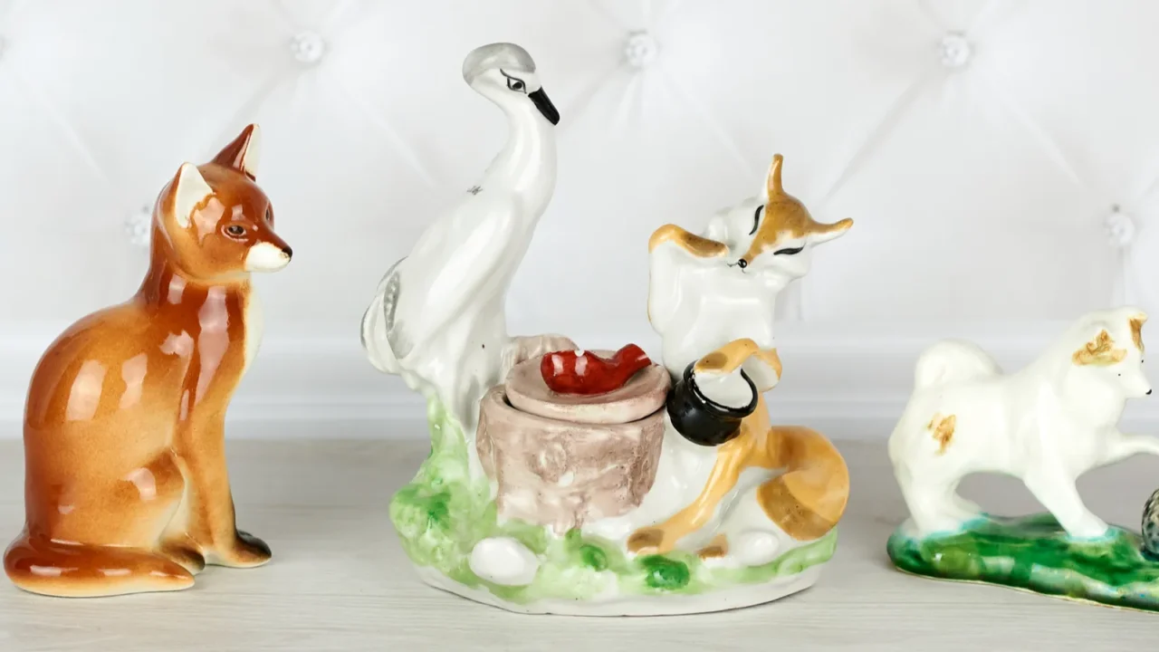 collection of three porcelain figurines  a fox sitting a