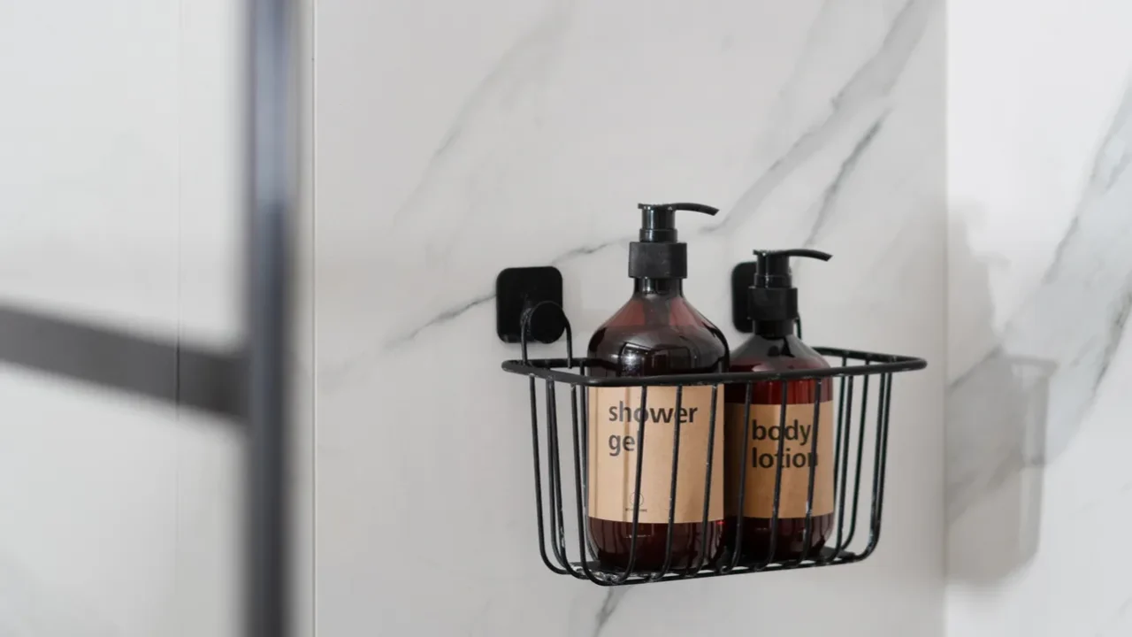 Compact black metal rack organizer/hanging shower caddy with shower gel and body.