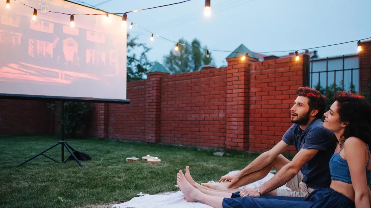 couple in love watching a movie in twilight outside on