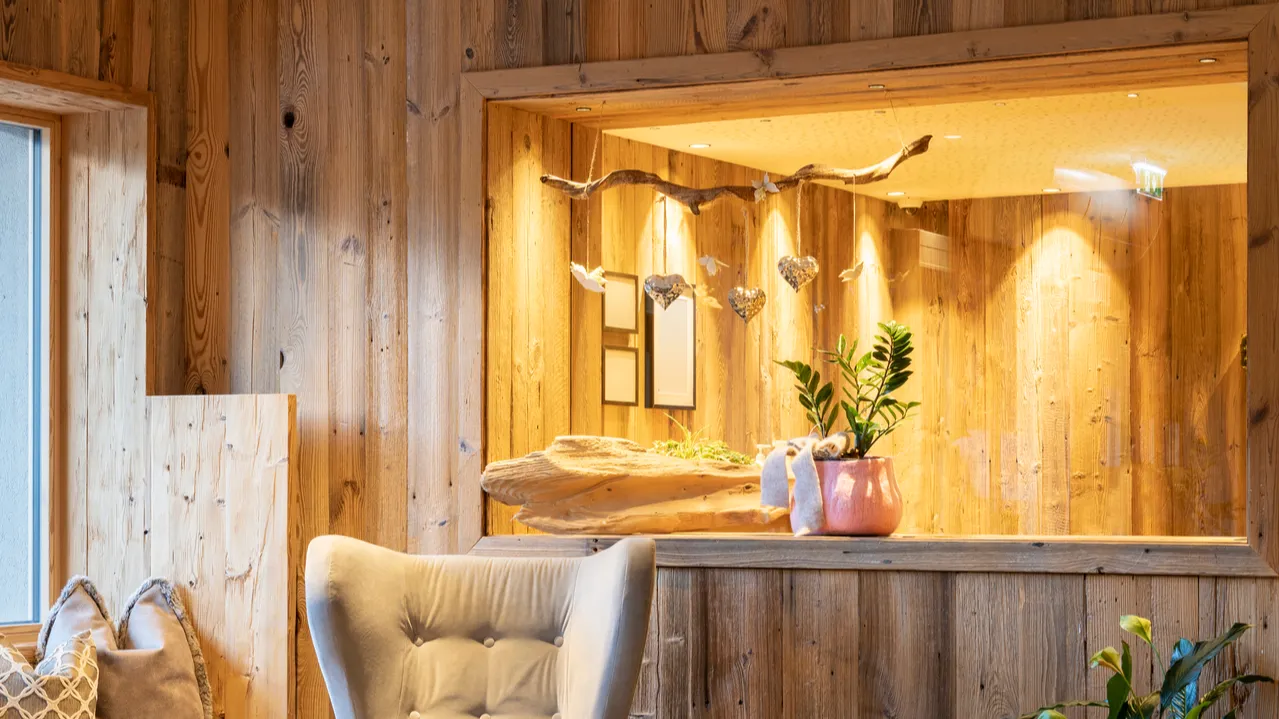 Cozy rustic seating area with old wood glass lights and driftwood hanger.