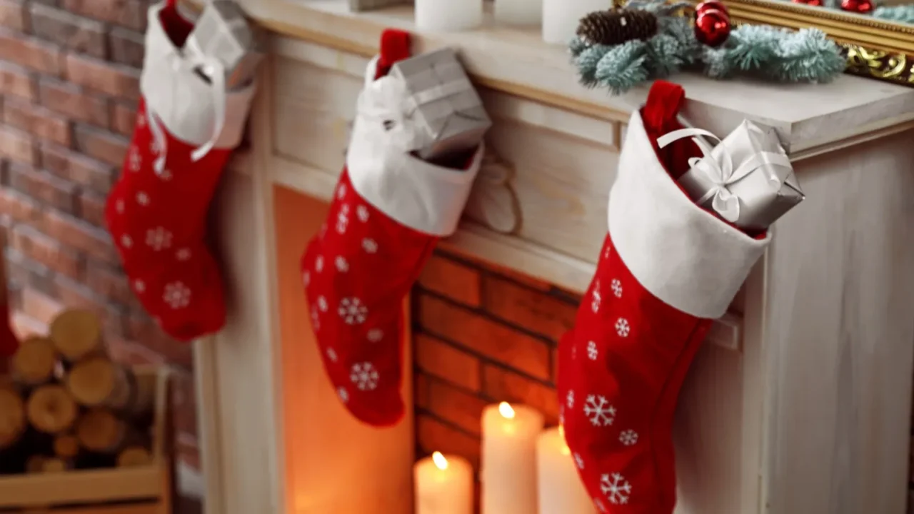 decorative fireplace with christmas stocking and gifts in stylish room