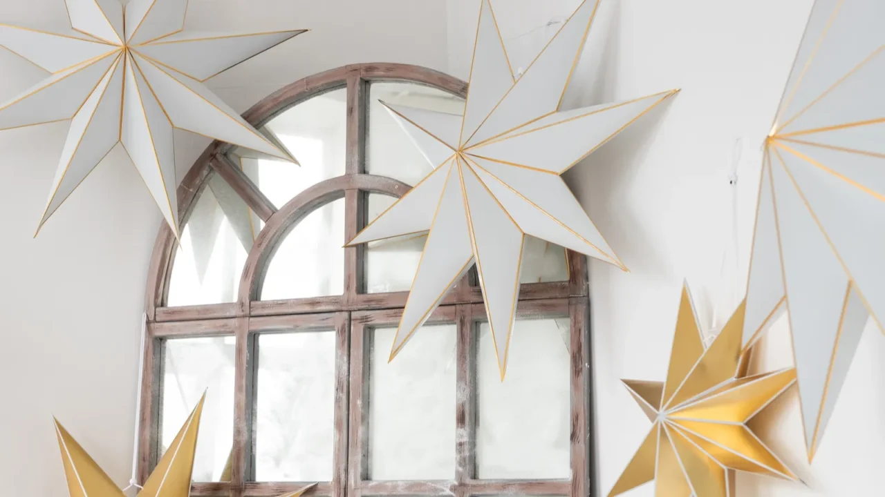 delicate paper stars adorn a vintage mirror in a bright