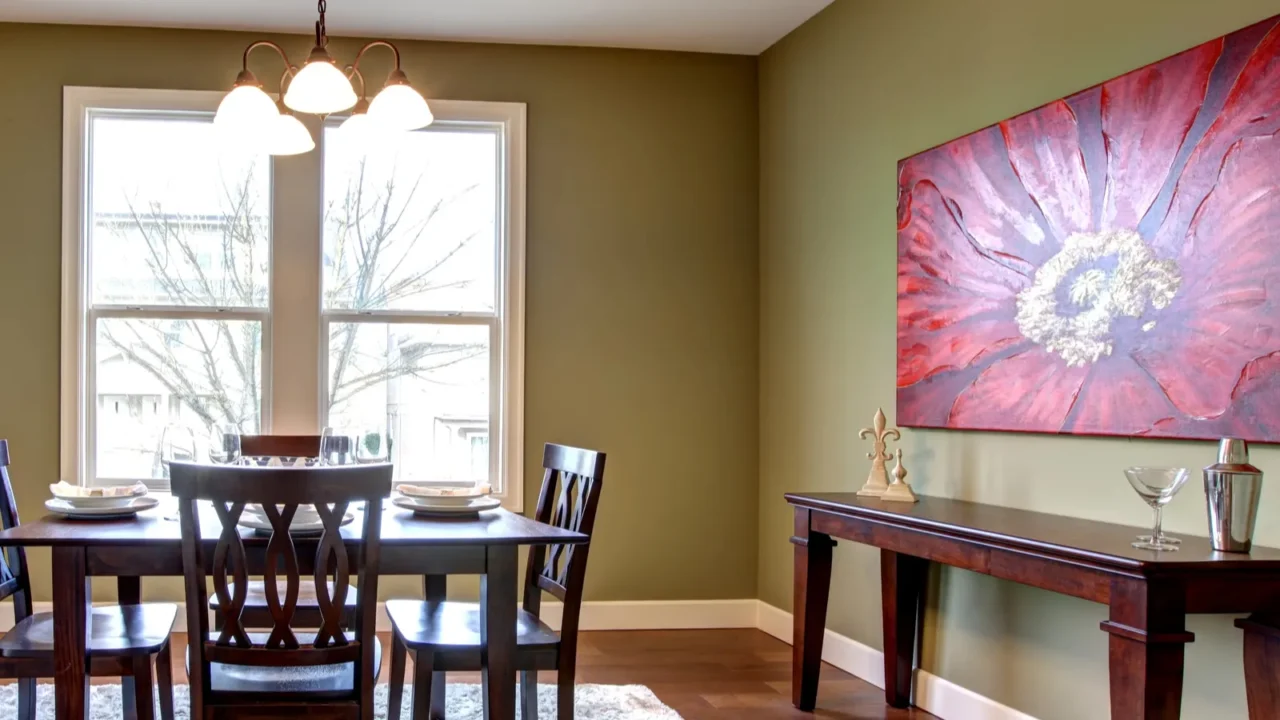 dining room with green walls and red painting