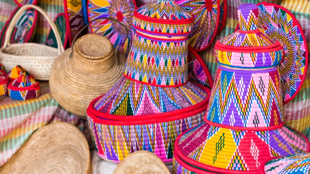 A colorful variety of African woven baskets display.