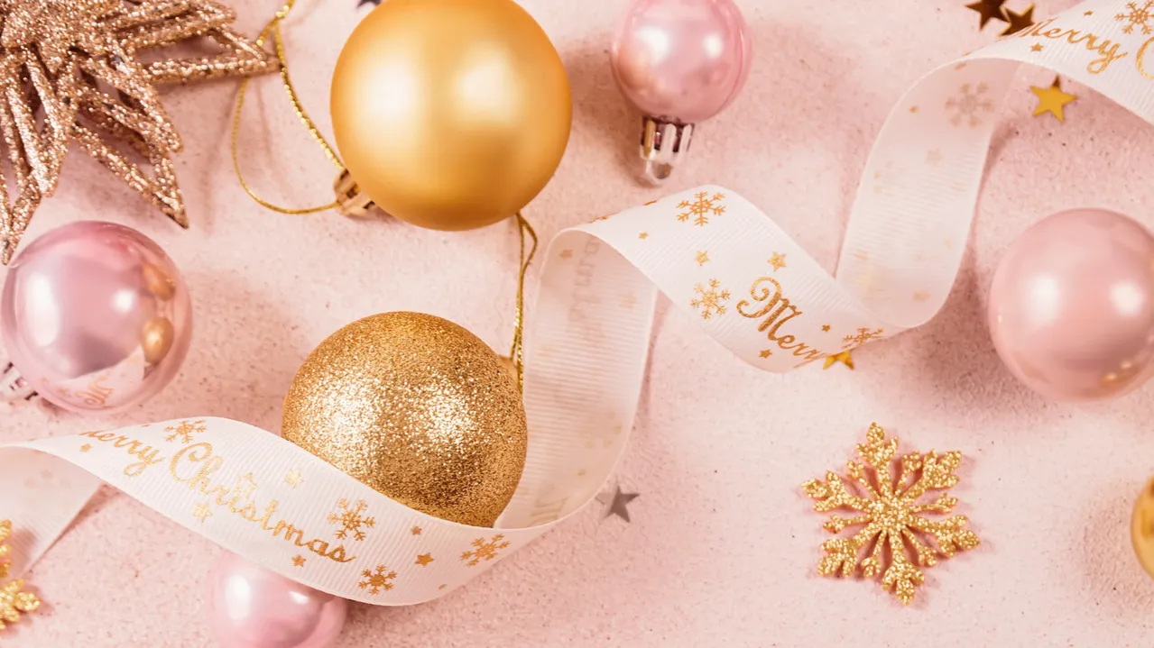 Festive Christmas and new year background with gold and pink.