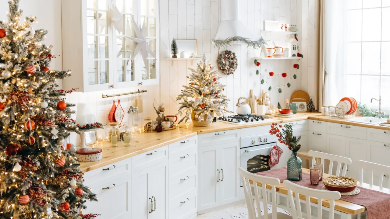 festive kitchen decorated for christmas with frosted trees red and