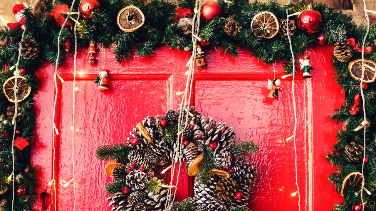 fragment of red wooden door with christmas decoration