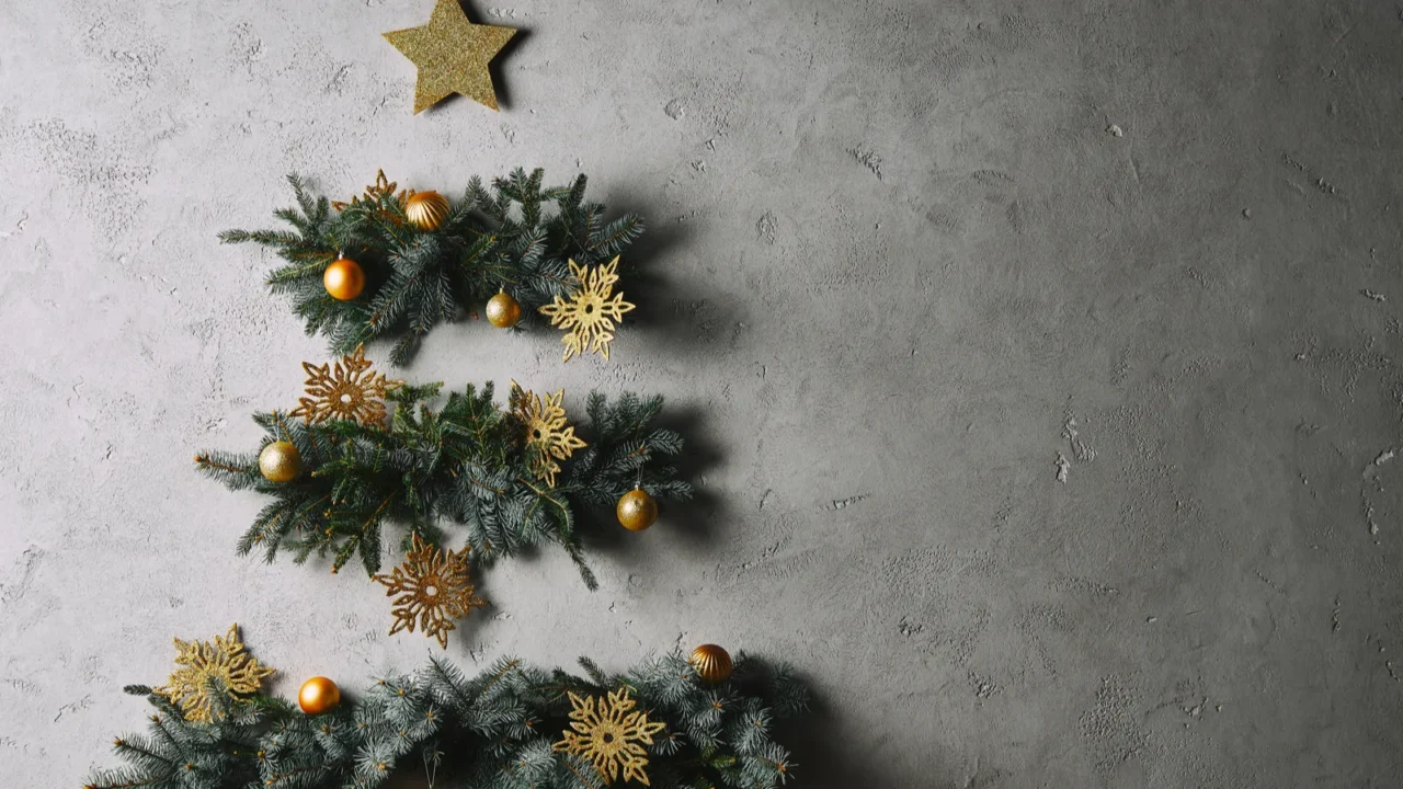 handmade christmas tree hanging on grey wall in room