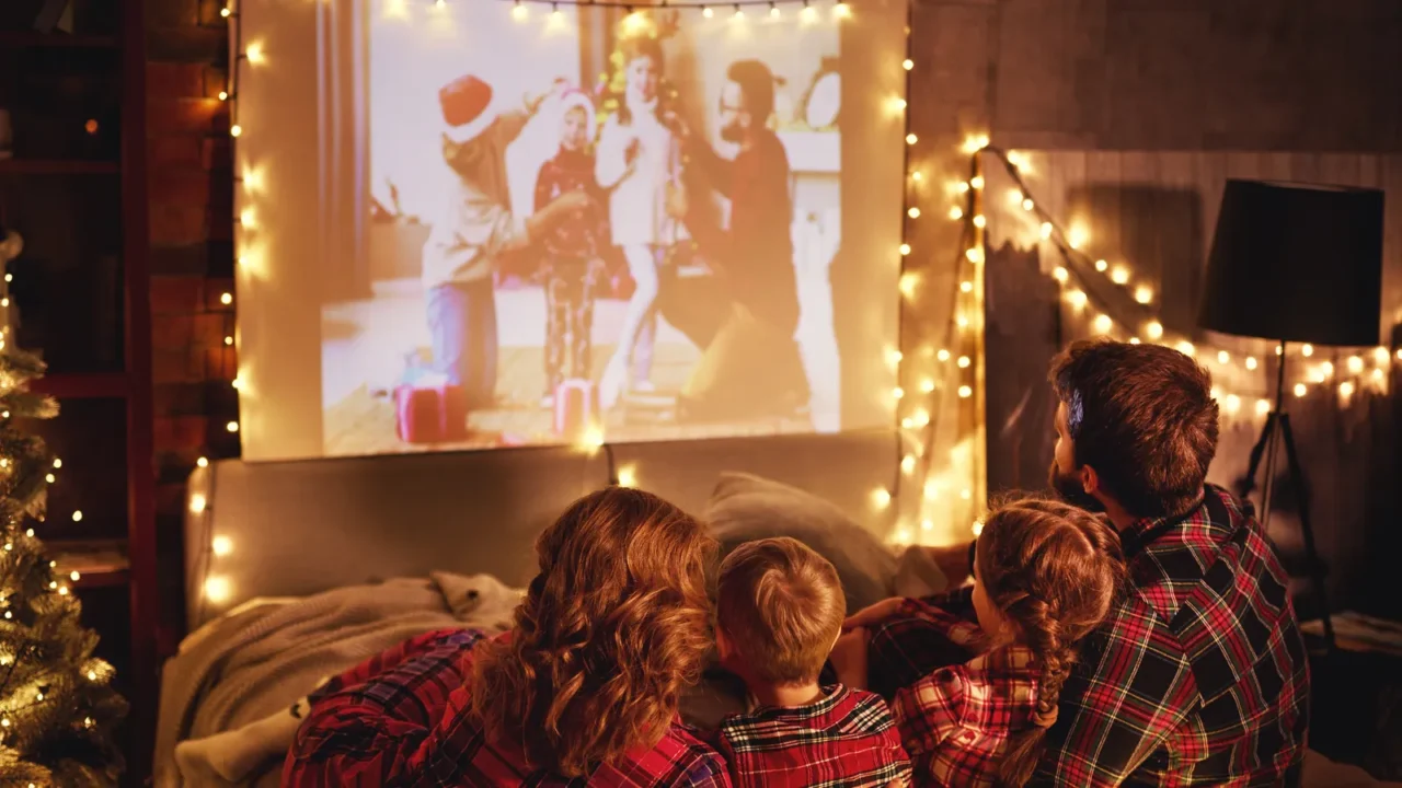 happy family in checkered pajamas mother father and children watching