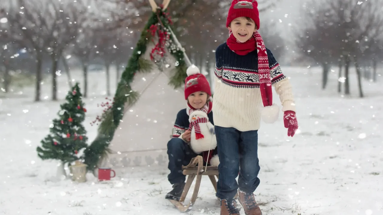 happy family with kids having fun outdoor in the snow