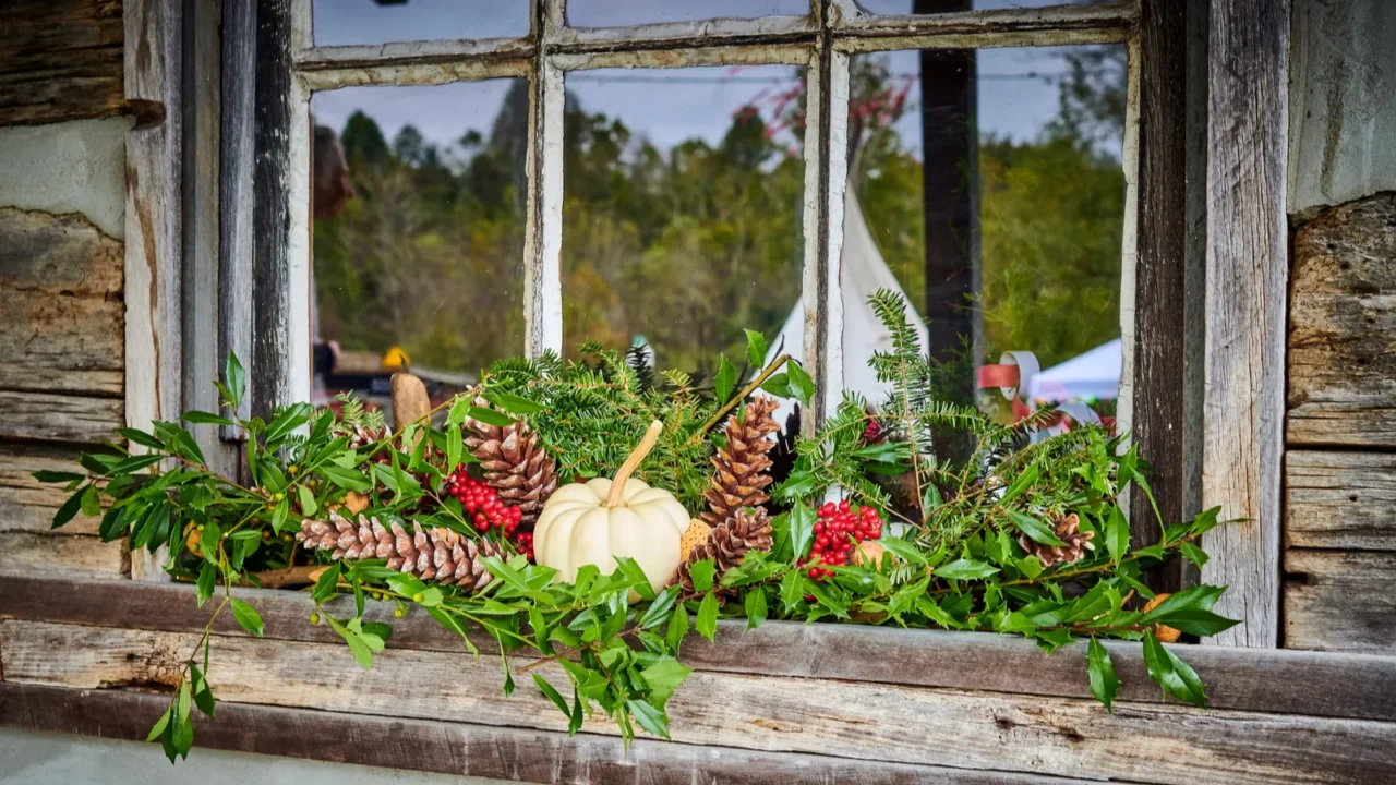 holiday window with garland on an old cabin