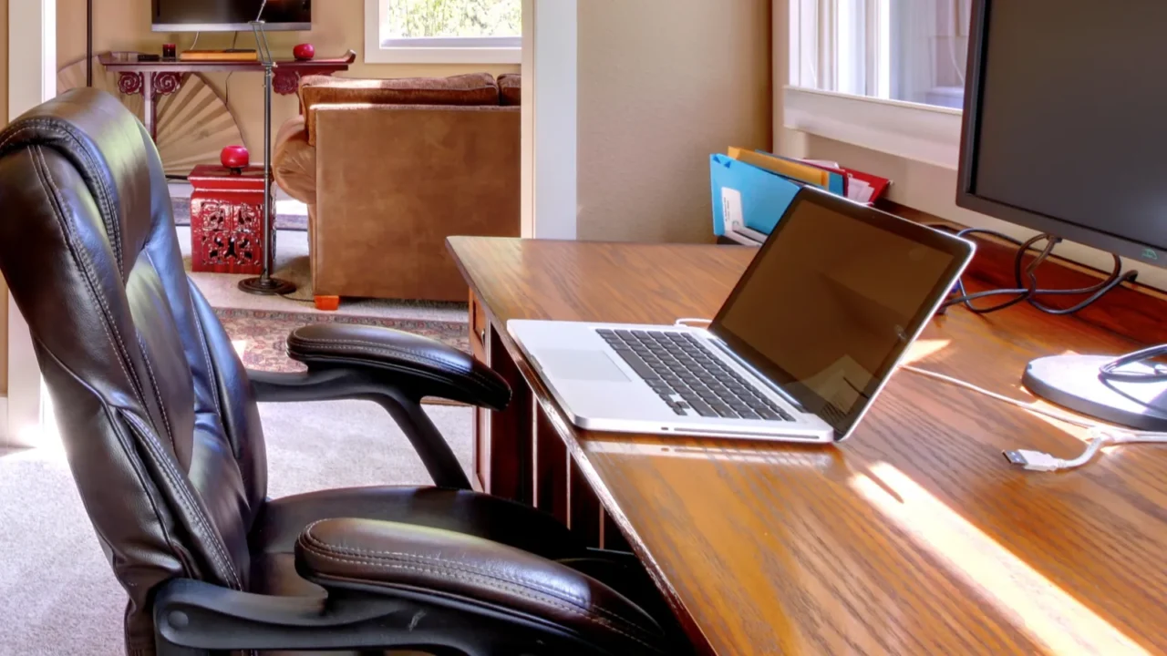 home office and computer and chair with brown walls