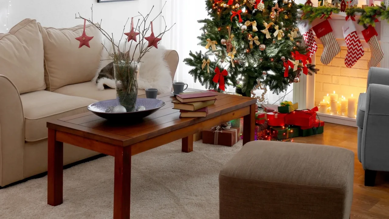 A cozy living room decorated for Christmas, featuring a tree, gifts, and a warm, inviting atmosphere.