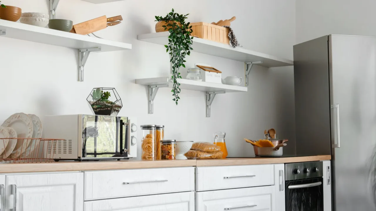 interior of light kitchen with stylish fridge counters and shelves