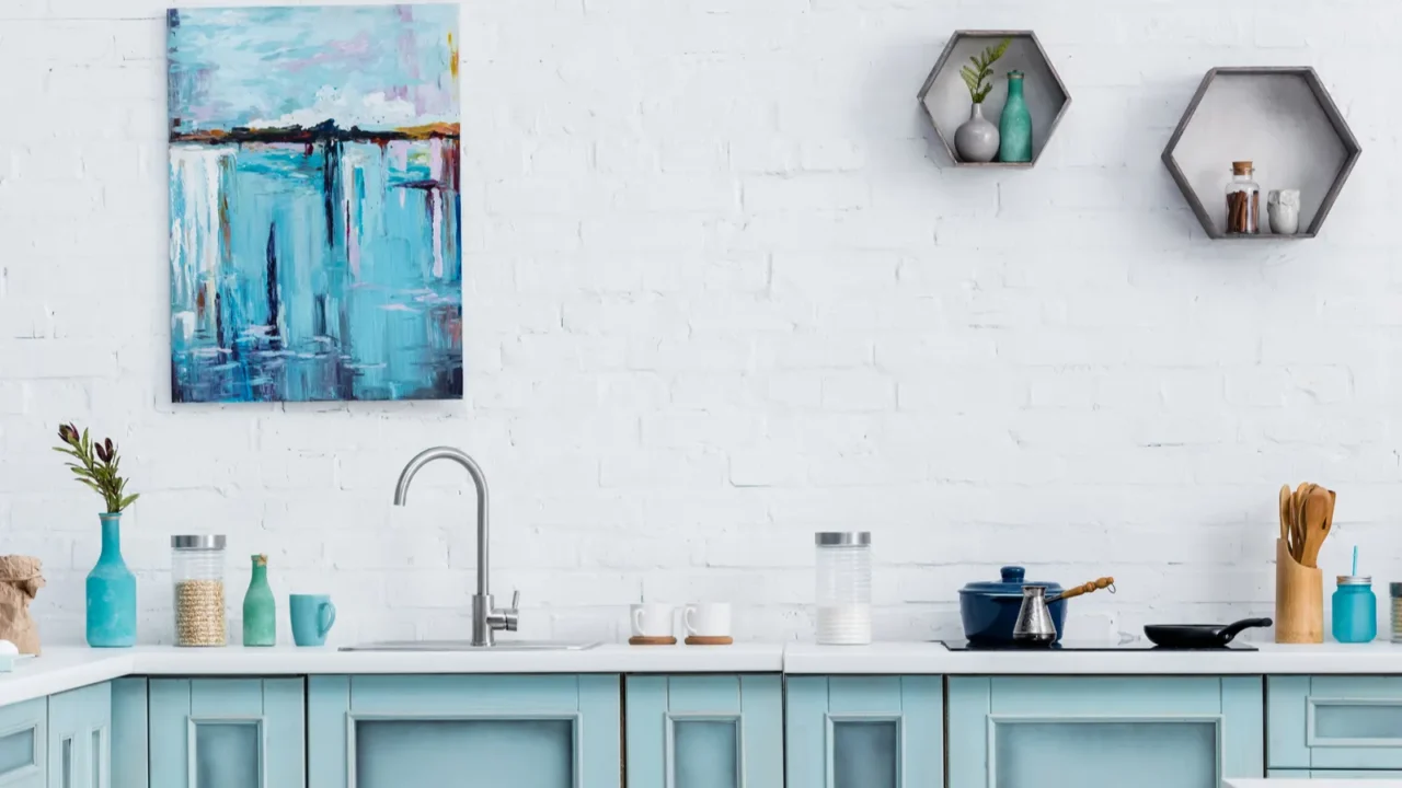 interior of modern turquoise kitchen with painting on white brick