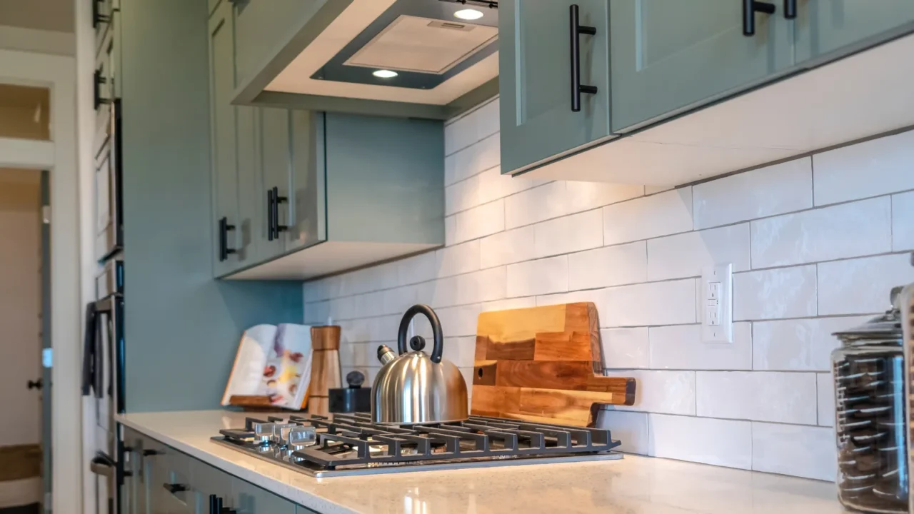 kettle on cooktop fixed on white countertop with cookie jars