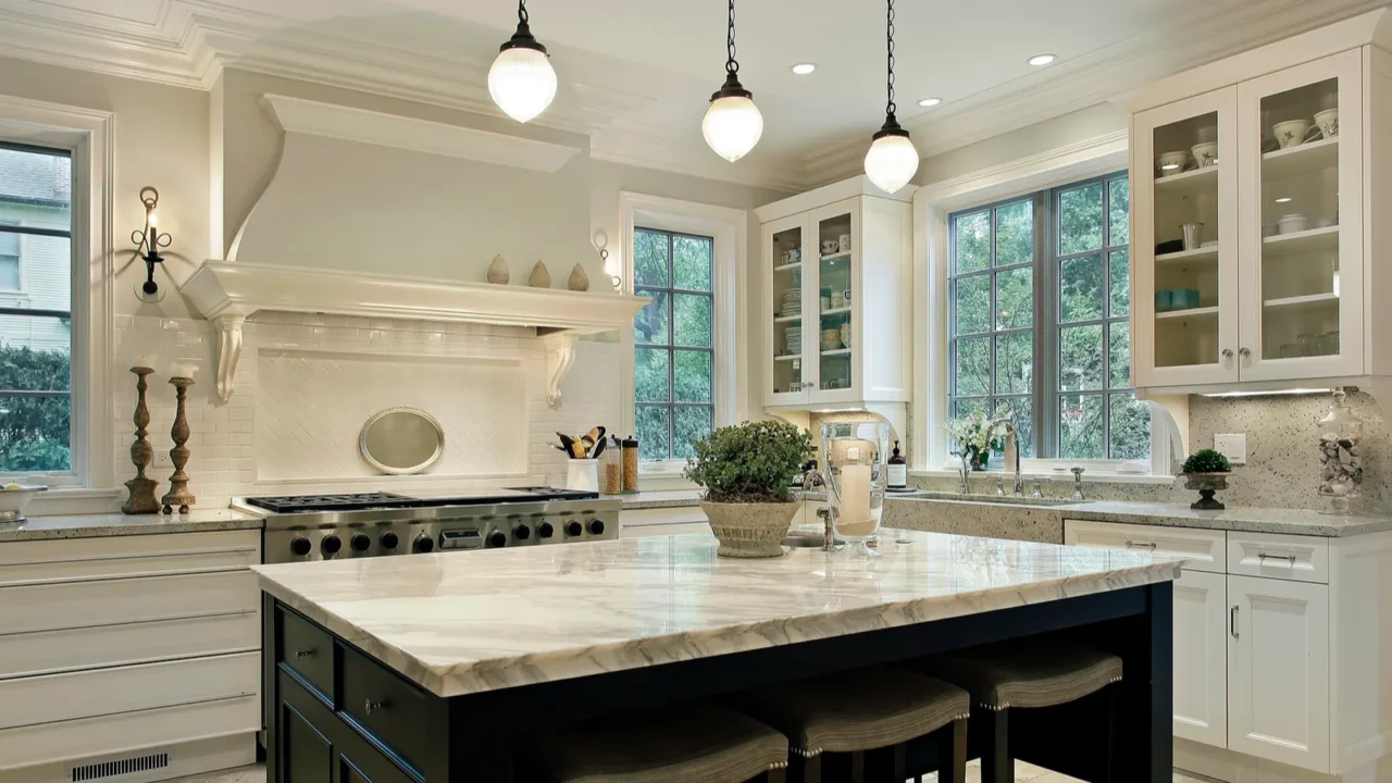 Kitchen with granite countertops and pendant lights.