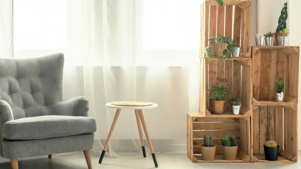 Living room with armchair and DIY wooden crate shelves,