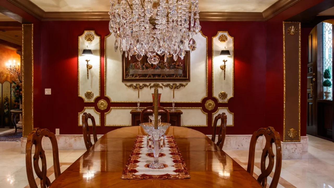 A luxury dining room with red and gold accents.