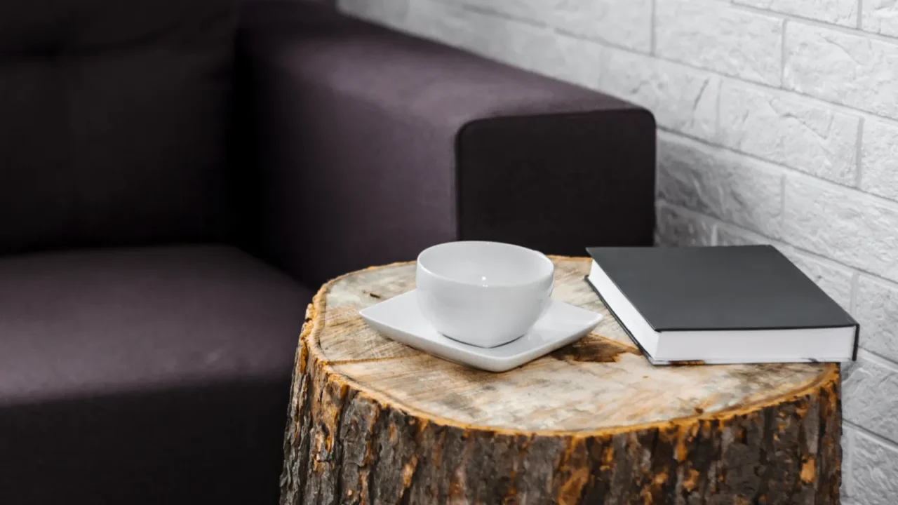 magazines and a cup of coffee on a wooden coffee table. creative stump table design