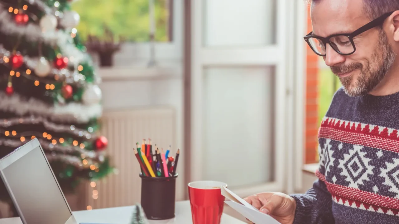 man opening christmas letter