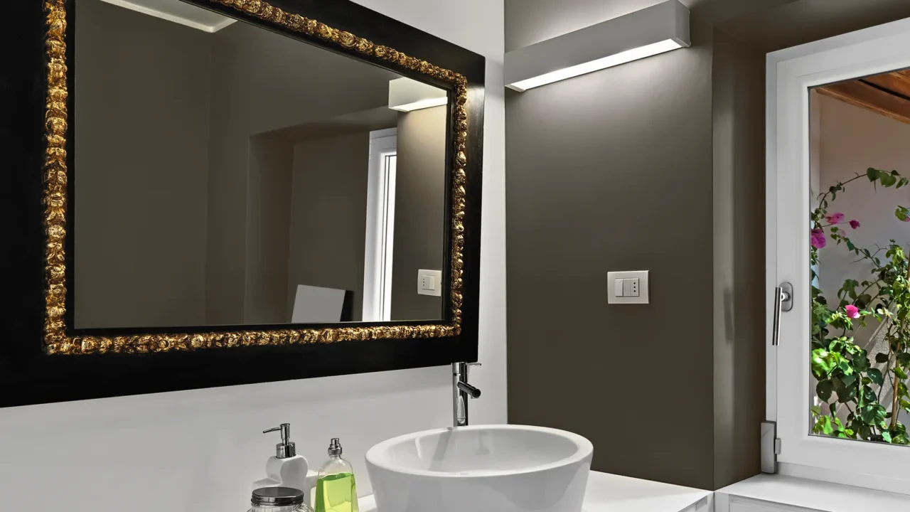 modern bathroom interior with large mirror above the bathroom sink