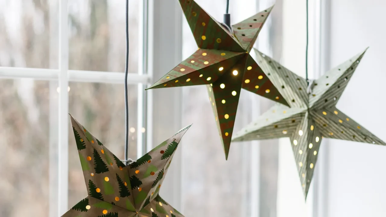 new year and christmas concept decorative paper stars hanging beside