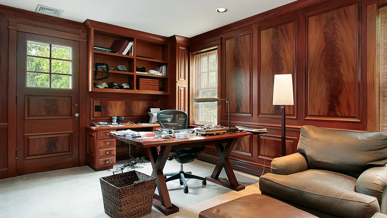 Home office in dark brown theme with a brown leather sofa and foot rest