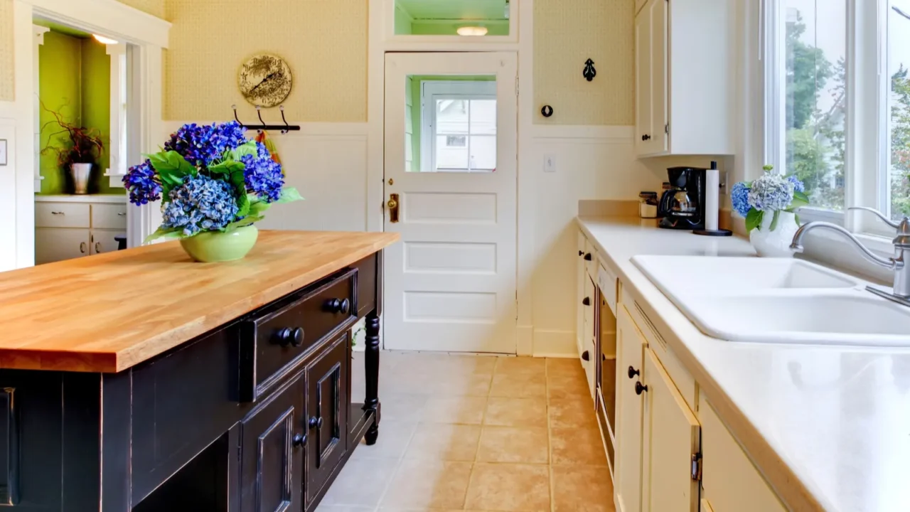 old antique white kitchen with black island and sink