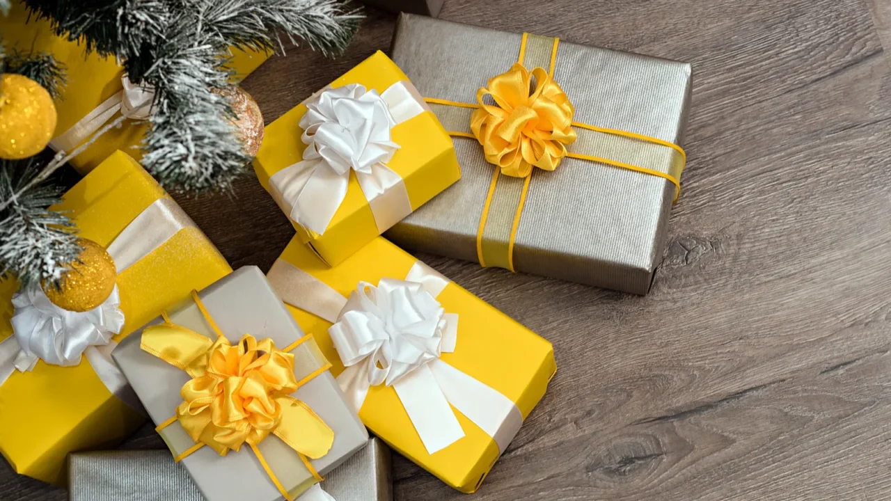 pile of yellow and grey christmas gifts