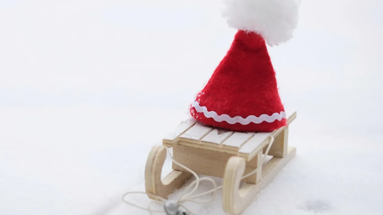 santa claus hat on a wooden made sleigh