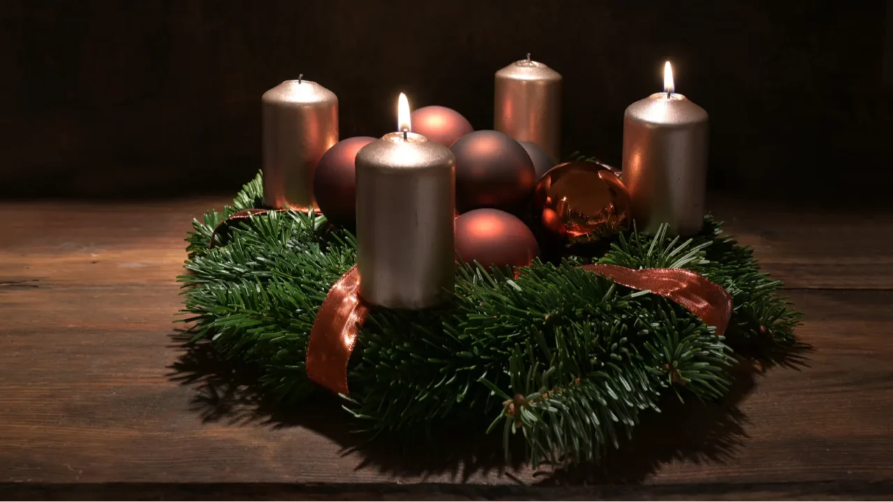 Second advent wreath with copper colored candles and christmas decoration.