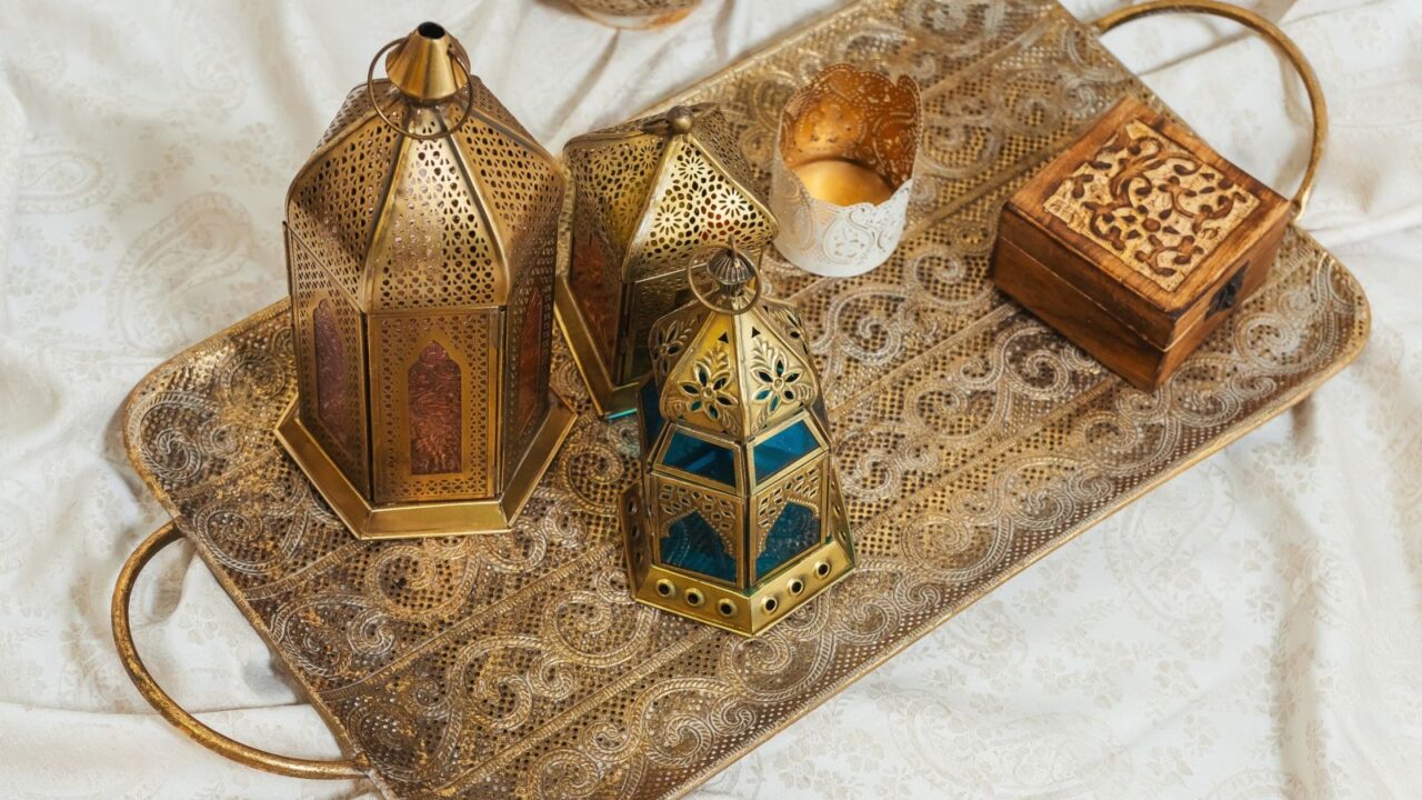 Oriental bronze lanterns on a gold carved tray interior details. Metal lanterns, candle holders in Arabic style. Decoration in Oriental style design.