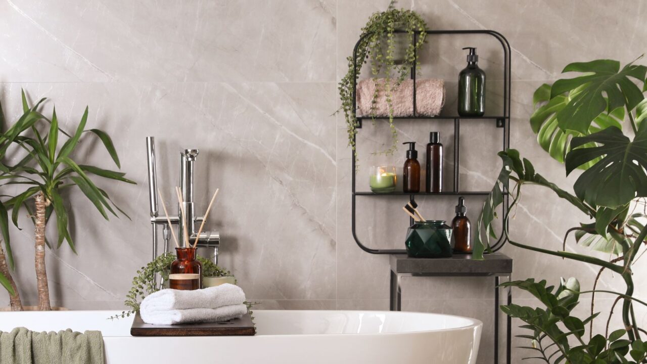 Modern white tub, beautiful green plants, and a vertical shelf in bathroom, Interior design.