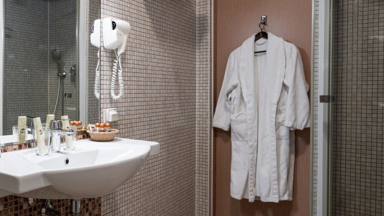 Bathroom interior in beige color with a over-the-door hook.