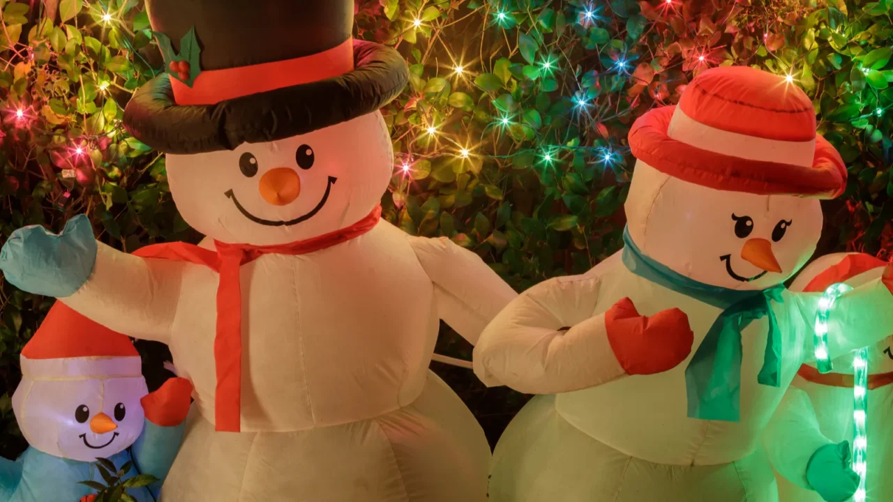 snowman family decorating front yard at night palo alto california