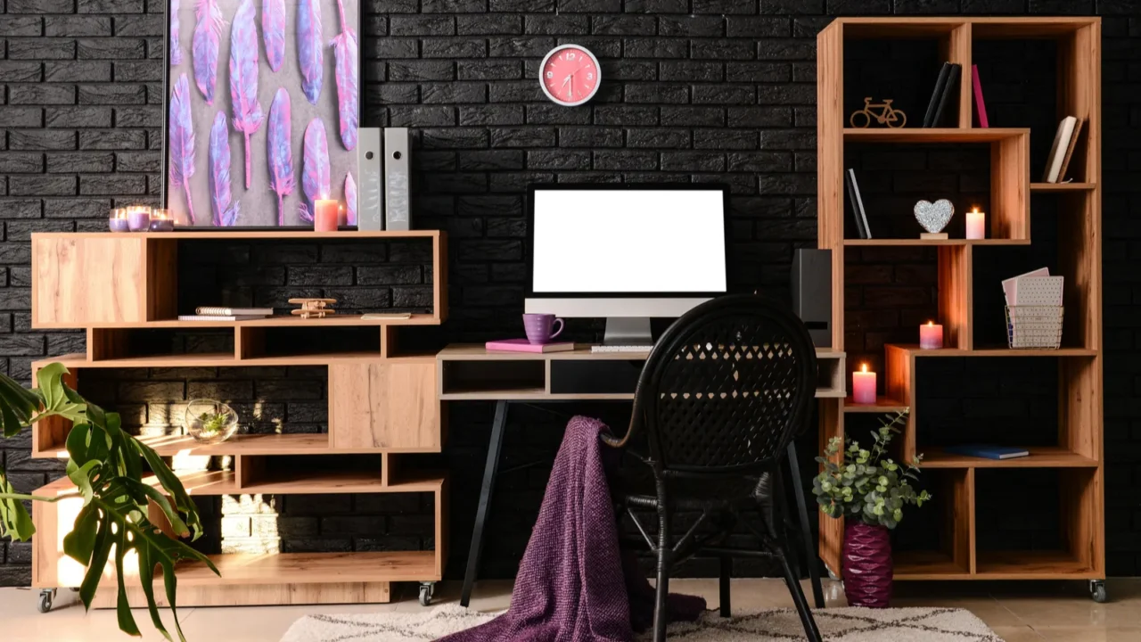 stylish workplace with modern computer near dark brick wall