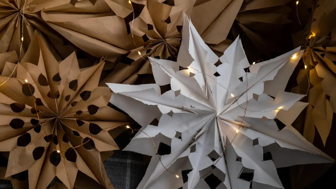 Sustainable Christmas decorations. Handmade paper stars with fairy lights. DIY Christmas ornaments.