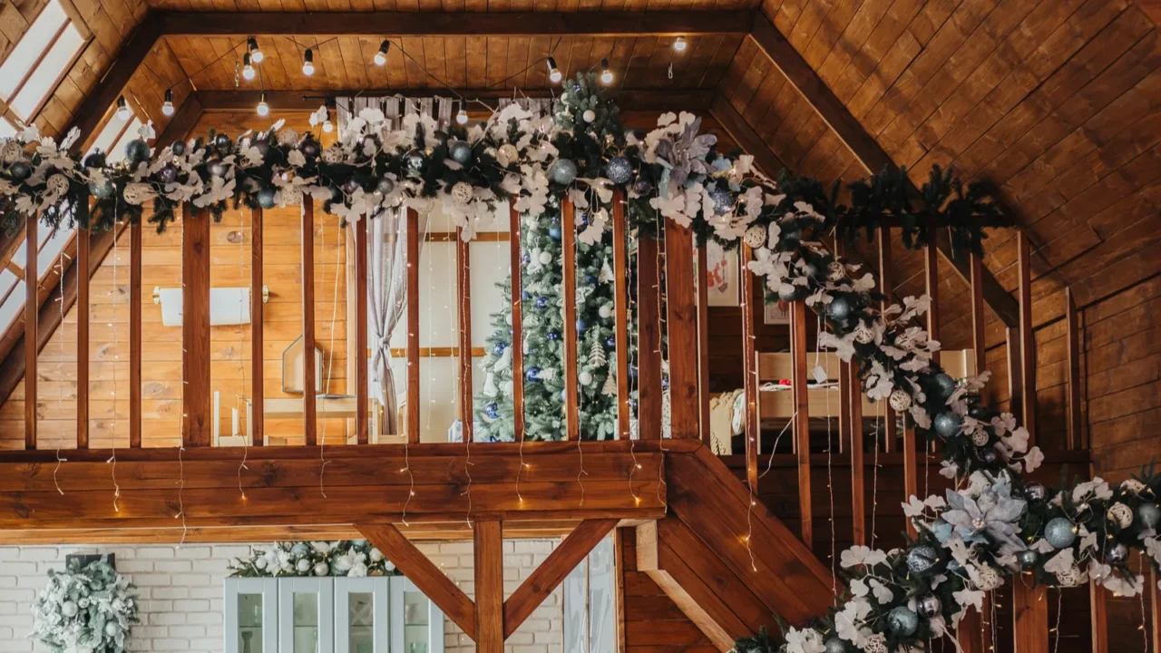 Festive decoration on the staircase of a wooden cabin house.