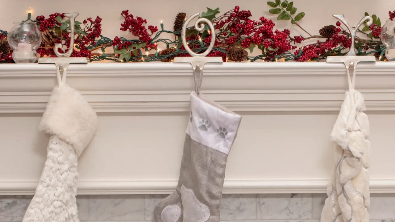 three christmas stockings on a fireplace mantel