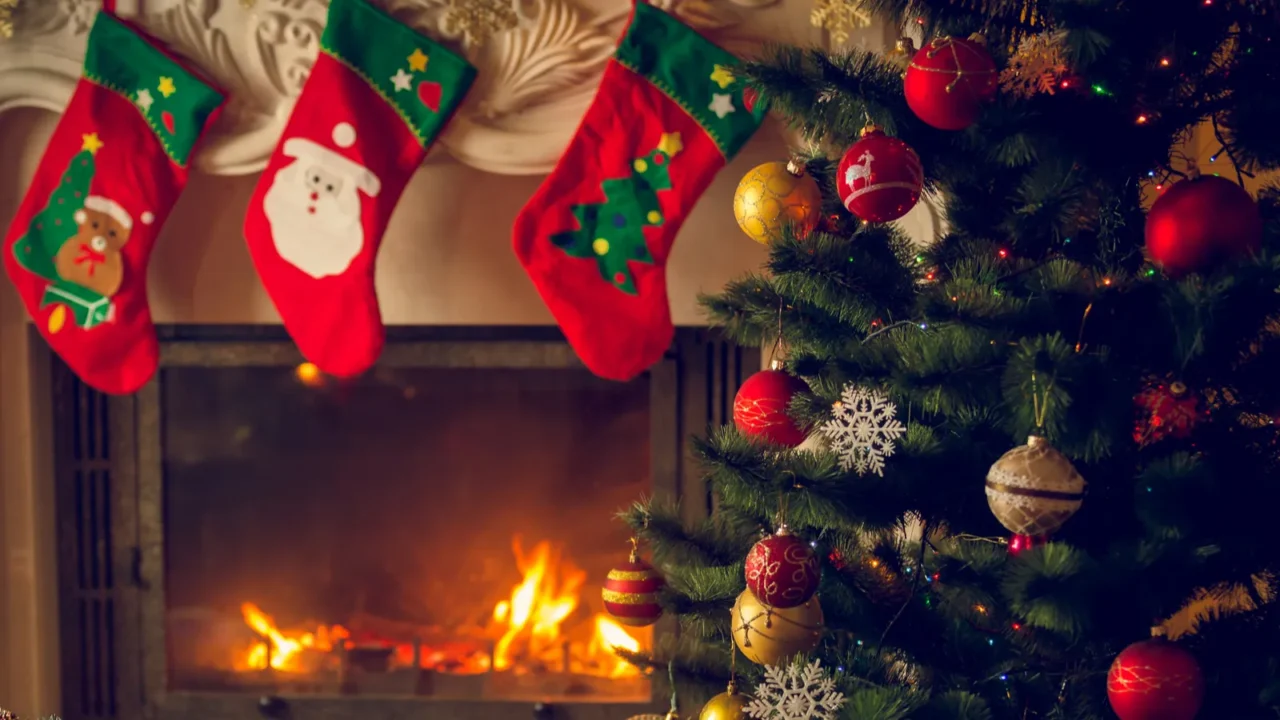 toned image of wooden table in front of decorated fireplace