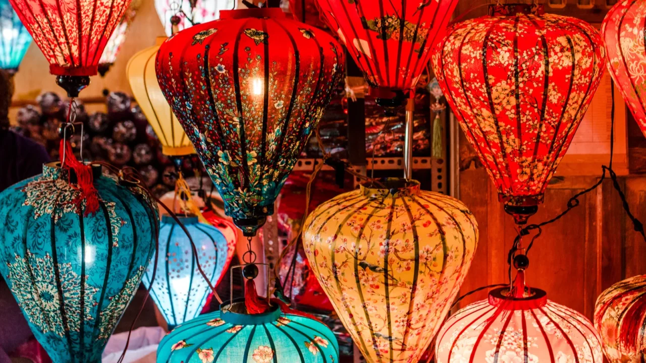 Traditional colorful Vietnamese silk lanterns spread light on a street.