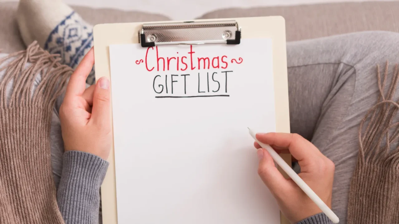 woman creating christmas gift list in cute socks