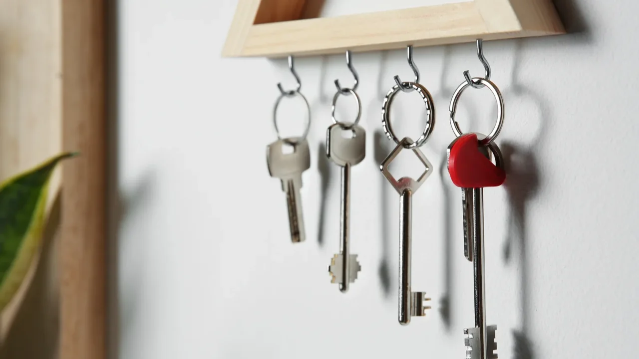 wooden key holder on light wall indoors