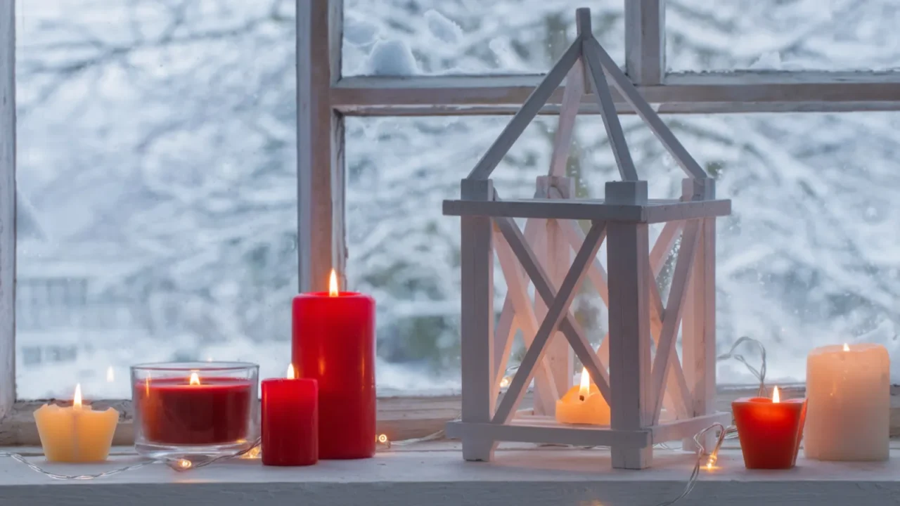 wooden lantern on windowsill on background winter landscape